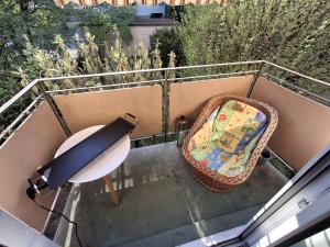 a balcony with a table and a suitcase on the stairs at Apartment in Basel Eurovision! in Basel