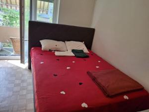 a bed with a red blanket with hearts on it at Apartment in Basel Eurovision! in Basel