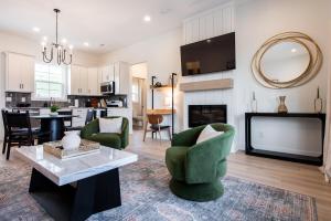 a living room with a couch and chairs and a table at Brand New House! Prime Location! in Jeffersonville