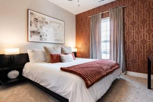 a bedroom with a large bed and a window at Brand New House! Prime Location! in Jeffersonville