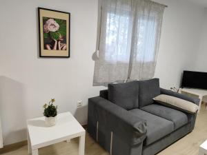 a living room with a couch and a table at My Flowers in Árgos Orestikón