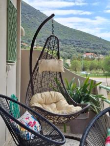 a hammock on a porch with a view of a mountain at Vitamin sea Apartment 4, Άνετο διαμέρισμα. in Almiropótamos
