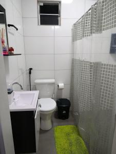 a bathroom with a sink and a toilet and a shower at Kitnet Sol e Lua in Caparaó Velho +14 photos