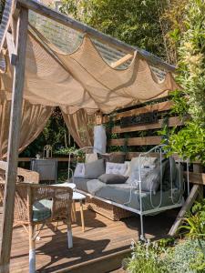 a porch with a couch and a swing at Les chambres du vieux quartier in Thouars