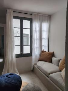 a living room with a couch and a window at Apartamento de diseño 2 habitaciones in Móra la Nova +7 photos
