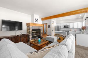 a living room with a couch and a fireplace at Birdie Glen Retreat - Golf course getaway with hot tub and office in McCall