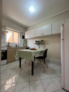 a kitchen with a table and a chair in it at MARINA HOUSE in Lixouri