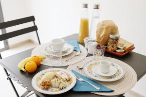 a table with three plates of food on it at Profumo di Calicanto in Tresnuraghes