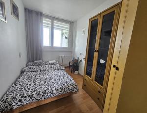 a bedroom with two beds and a large window at Apartament WELES in Bolesławiec +20 photos