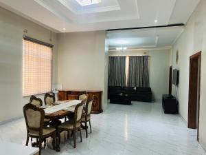 ein Esszimmer mit Tisch und Stühlen und einer Couch in der Unterkunft kafue Executive Family Residence in Kafue