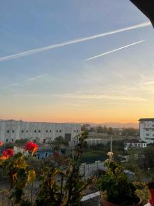 a view of a city at sunset from a balcony at Villa's Daci in Tirana +11 photos