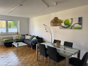 a living room with a couch and a table at gemütliche Ferienwohnung Anker in Schilksee am Strand in Kiel
