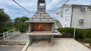 a brick oven with a fire inside of it at Apartment Stella in Ražanj