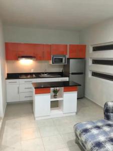a kitchen with white cabinets and a stove top oven at Departamento A Fracc Cd Del Valle in Tepic