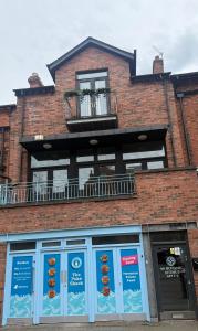 a facade of a brick building with donuts on display at Luxury Belfast Stay in Belfast