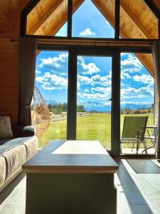 a room with a large window with a view of a field at Eternum Glamping in Žabljak