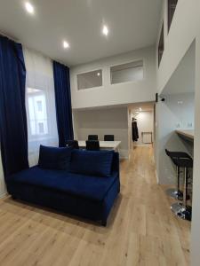 a living room with a blue couch and a table at Kielce City Center Paderewskiego 24 in Kielce