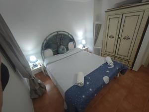 a bedroom with a bed with a blue blanket at Emadi House Porto Rotondo in Porto Rotondo