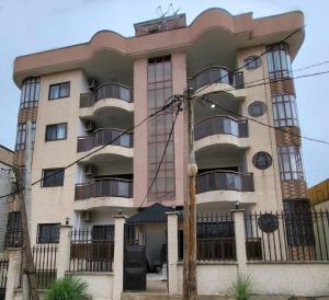 a building with a clock on the side of it at Résidence Belle Alliance in Yaoundé