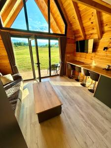 a living room with a wooden table in a cabin at Eternum Glamping in Žabljak