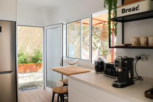 a kitchen with a coffee maker on a counter at Seashore Villa - Porto Santo in Porto Santo