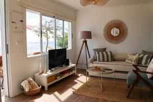 a living room with a couch and a tv at Seashore Villa - Porto Santo in Porto Santo