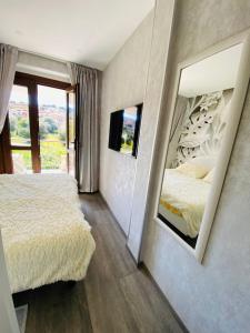 a bedroom with two beds and a large mirror at Hope House in Villasimius