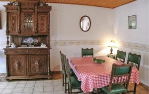 a dining room with a table with a green chicken on it at Lovely Home In Hames Boucres With Wifi in Hames-Boucres