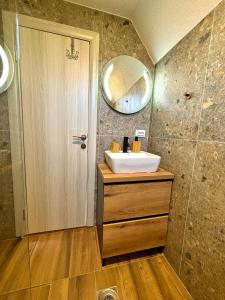 a bathroom with a sink and a mirror at Eternum Glamping in Žabljak