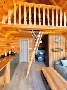 a loft bed in a log cabin at Eternum Glamping in Žabljak