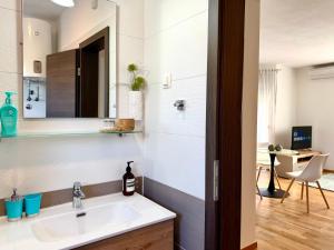 a bathroom with a sink and a mirror at Apartments Terra Solaris in Medulin