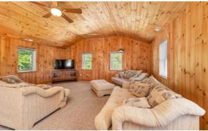 a living room with two couches and a tv at NEW Calm Cove Retreat w Dock & Beach in Alton