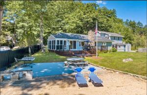 a house with a swimming pool with three blue chairs at NEW Calm Cove Retreat w Dock & Beach in Alton