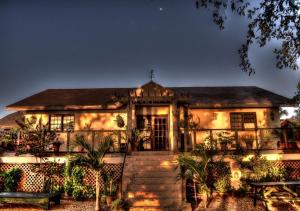a large house with lights on the side of it at CROOКED TREE LODGE Belize in Crooked Tree