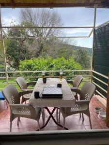a table and chairs on a deck with a view at Summer house Kruce in Kruče +18 photos