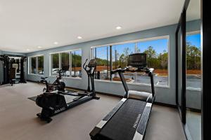 a gym with two treadmills and a treadmill at Everhome Suites Brownsville in Brownsville
