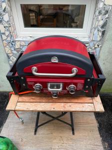a red suitcase sitting on top of a table at Chill and Grill for 2 in Vienna