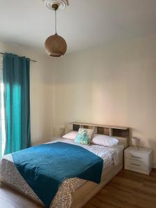 a bedroom with a bed with a blue blanket at Anastasias Holiday House in Stavros