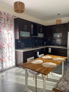 a kitchen with a wooden table in a kitchen at Anastasias Holiday House in Stavros