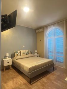 una camera da letto con un letto e una grande finestra di Residence Quedar a Melfi