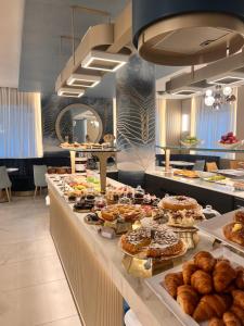 a buffet line with many different types of pastries at Hotel Villa Paola in Rimini +144 photos
