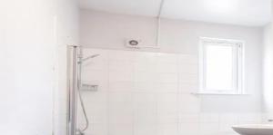 a white bathroom with a shower and a sink at CasaVacanze NewlyRenovated Luxury in Illes Balears