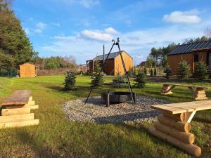 a park with a picnic table and a playground at Ostoja Wycinki domki letniskowe in Jaszczerz