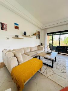a living room with a couch and a table at Villa 228 Dyar Shemsi in Taroudant