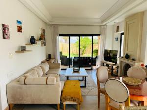 a living room with a couch and a table at Villa 228 Dyar Shemsi in Taroudant