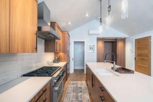 a kitchen with white counter tops and wooden cabinets at Upscale Condo Near Lift and Town with Mountain Views in Telluride