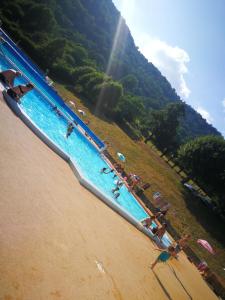 a group of people on a beach near a mountain at Ferme traditionnelle in La Jarriage