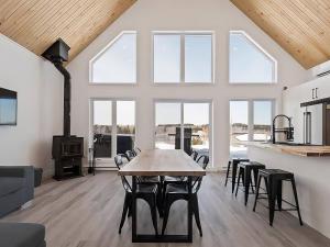a large kitchen with a table and chairs in a room at Le Chal'Heureux in Saint Adelphe