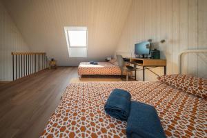 a bedroom with two beds and a desk with a computer at Svencelė K-17 in Svencelė