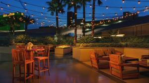 a patio with a table and chairs and lights at MGM 1BR Suite 7th Floor Strip View, Balcony in Las Vegas